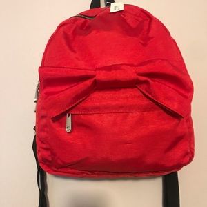 Red backpack with bow